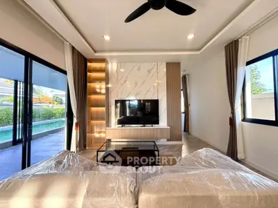 Luxurious living room with modern decor and poolside view