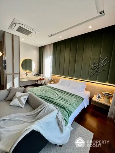 Luxurious bedroom with elegant green accent wall, ambient lighting, and modern furnishings, showcasing a sophisticated urban living space.