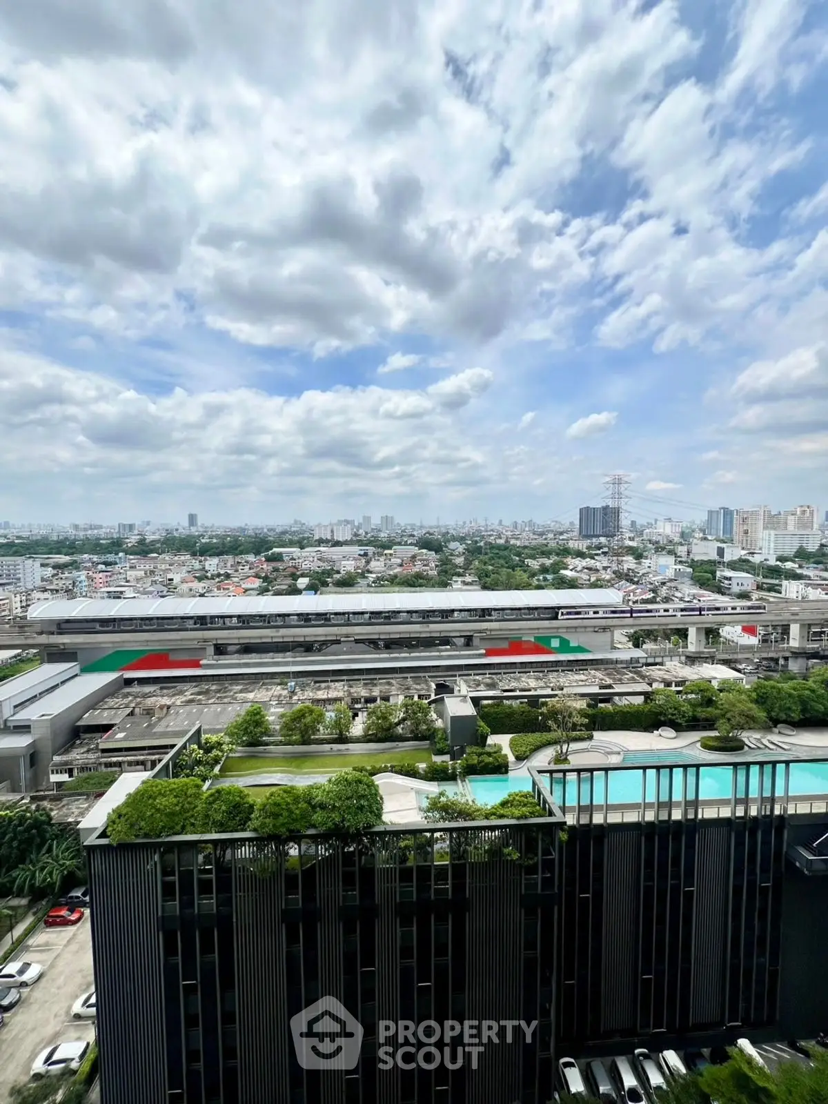 Stunning cityscape view with modern building and pool, perfect for urban living.