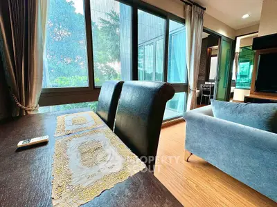 Spacious living room with large windows and elegant decor in modern apartment