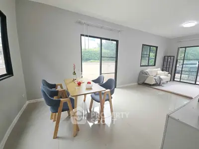 Spacious modern living room with dining area and large windows