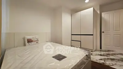 Modern bedroom with sleek wardrobe and comfortable bed in a stylish apartment.
