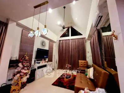 Luxurious living room with high ceilings, modern decor, and festive Christmas tree.