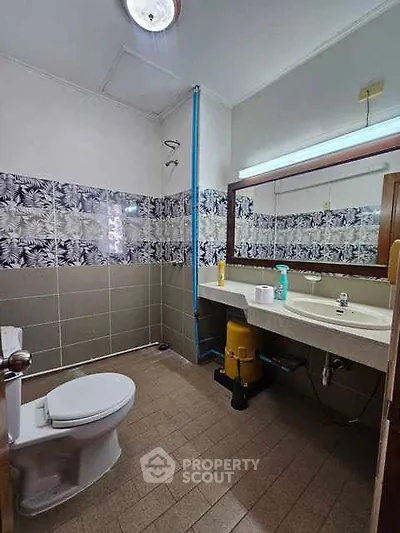 Spacious bathroom with modern fixtures and stylish tile design.