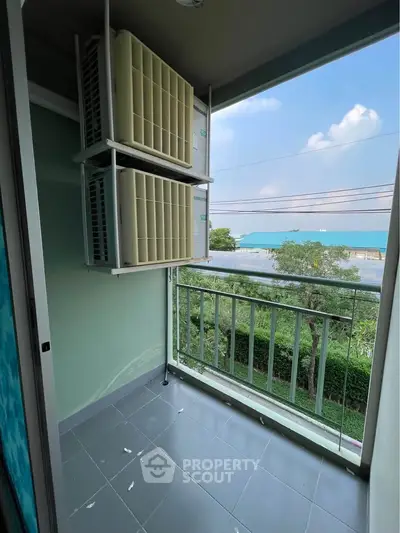 Compact balcony with air conditioning units and scenic view