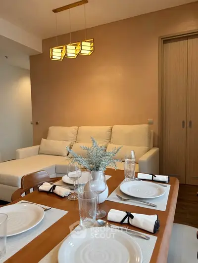 Elegant living room with modern dining setup and cozy sofa, perfect for stylish urban living.