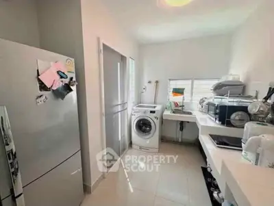 Modern kitchen with sleek appliances and ample natural light