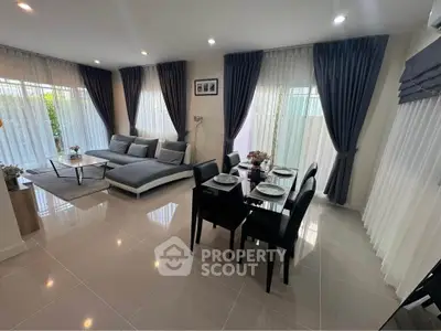 Modern living room with elegant dining area and large windows