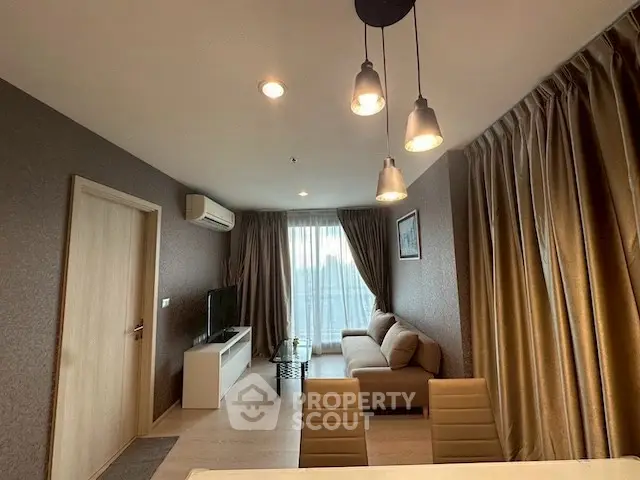 Modern living room with cozy sofa and stylish lighting in elegant apartment.