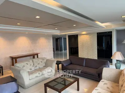 Spacious living room with modern decor and elegant lighting