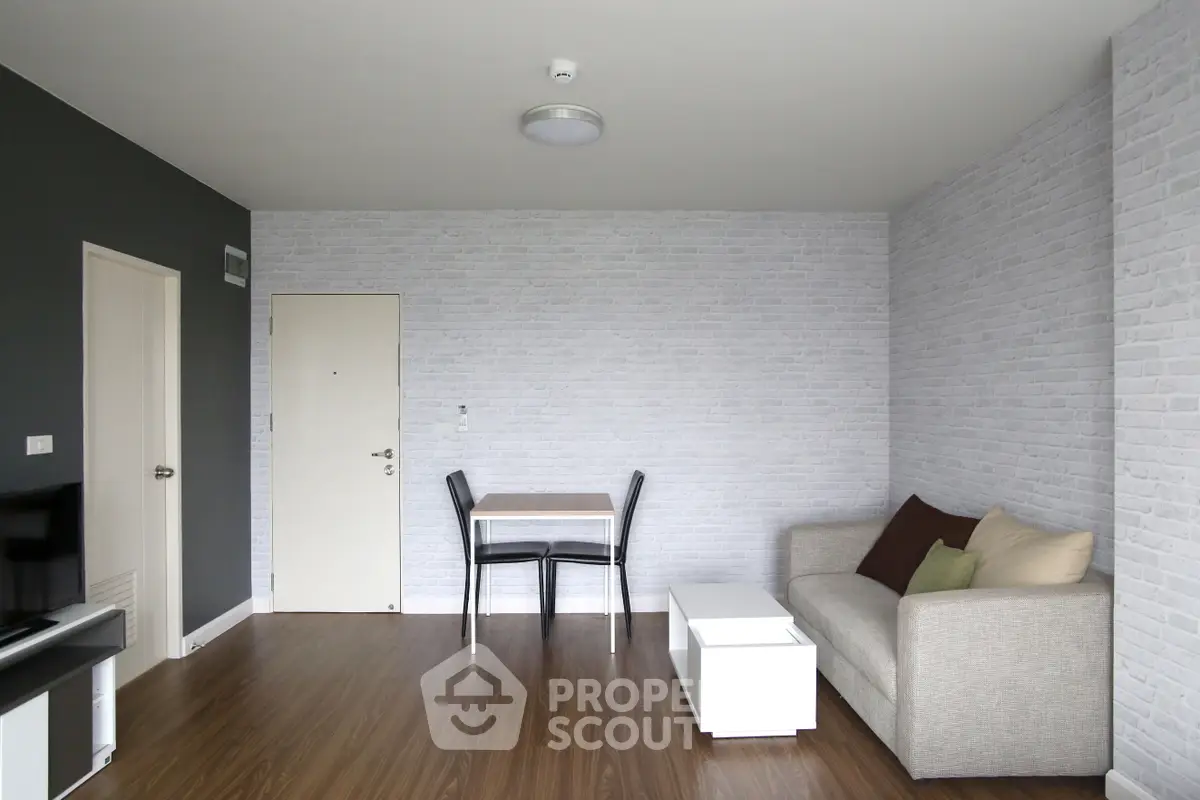 Modern living room with minimalist decor and cozy seating area, perfect for relaxation.