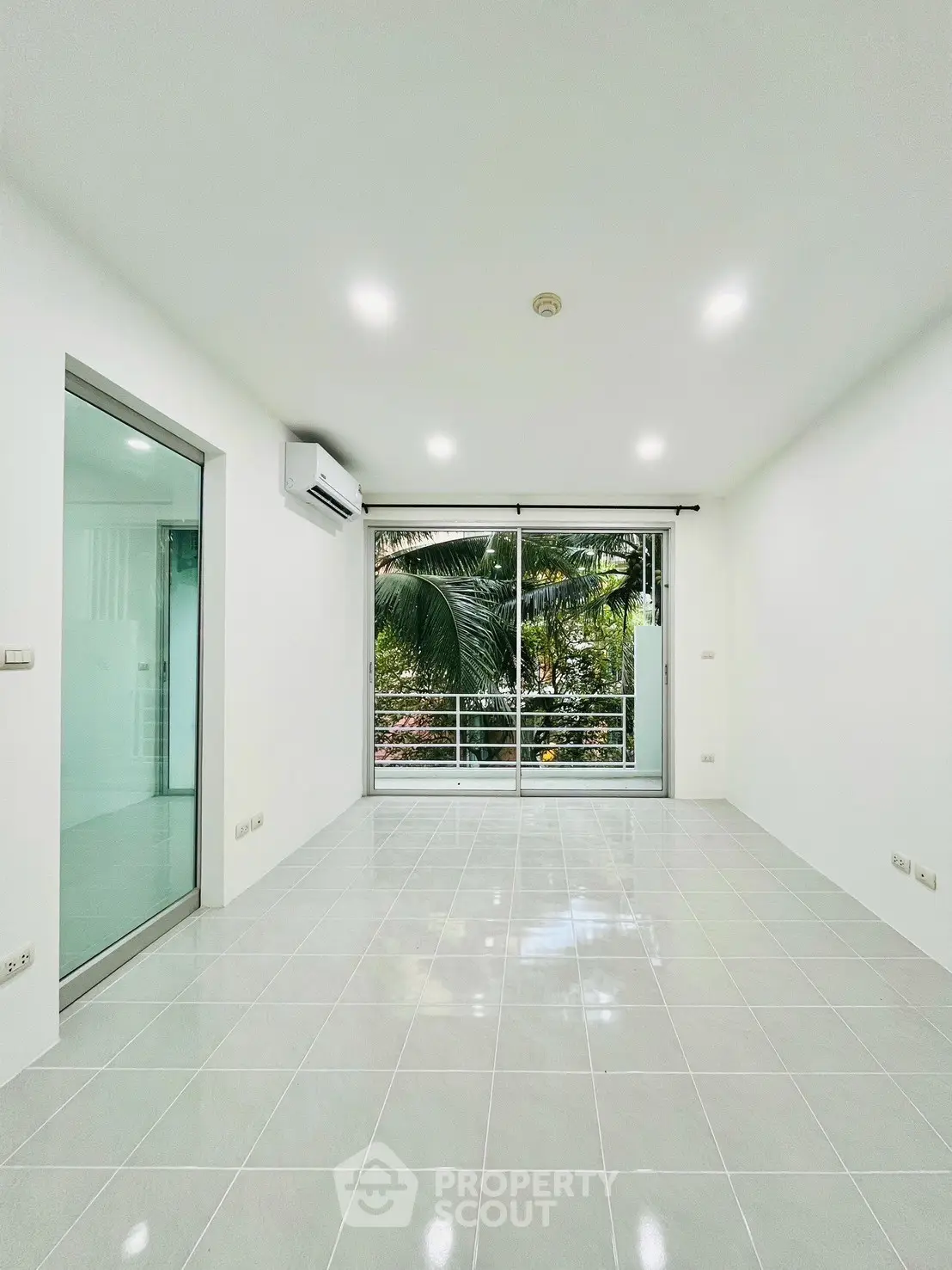 Bright modern living room with large sliding glass doors and garden view.