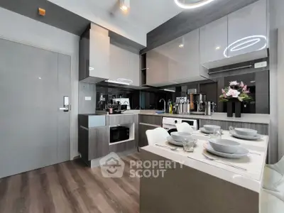 Modern kitchen with sleek cabinetry and dining area in stylish apartment