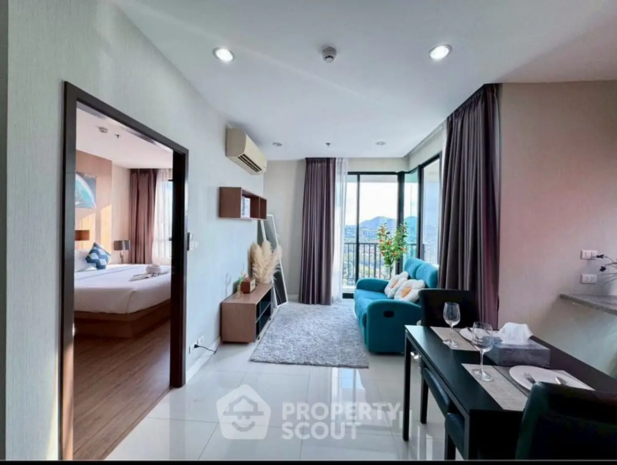 Modern open-plan living room with balcony and scenic view