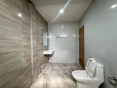 Spacious modern bathroom with sleek tile design and contemporary fixtures.
