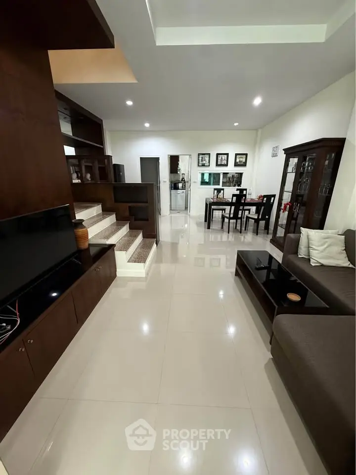 Spacious modern living room with elegant dining area and sleek furniture