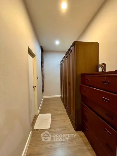 Spacious storage room with elegant wooden cabinets and warm lighting
