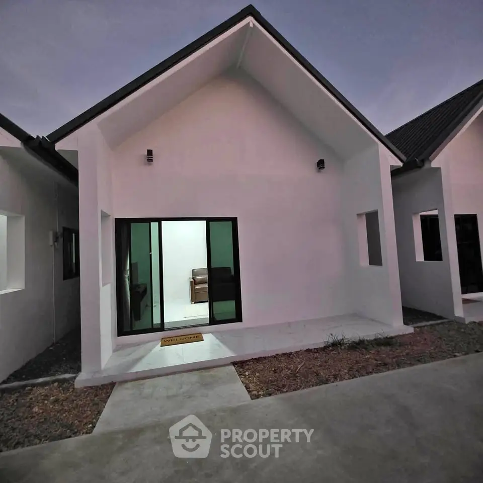 Modern minimalist house exterior with sleek design and large glass doors