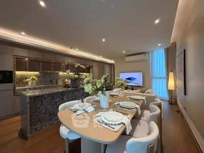 Luxurious open-plan kitchen and dining area with elegant decor and modern appliances.