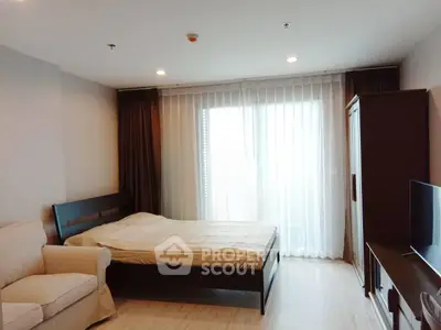 Spacious bedroom with modern furnishings and natural light