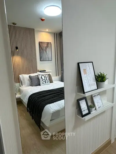 Modern bedroom with stylish decor and cozy ambiance, featuring elegant wall art and soft lighting.