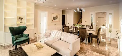 Luxurious open-plan living and dining area with elegant furnishings and ambient lighting.