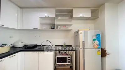 Modern kitchen with sleek white cabinets and stainless steel appliances