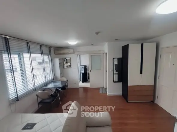 Modern studio apartment with wooden flooring and stylish furniture