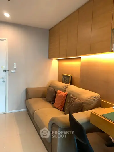 Cozy living room with plush sofa and warm lighting, perfect for relaxation.