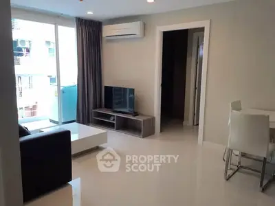 Modern living room with sleek furniture and large window in a stylish apartment.