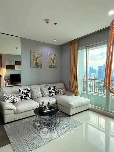 Modern living room with city view, stylish decor, and large windows in a high-rise apartment.