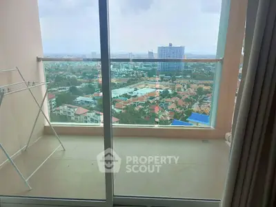 Spacious balcony with stunning city view in modern high-rise apartment.