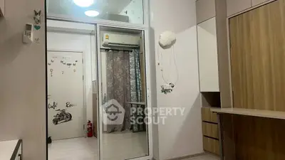 Modern bedroom with mirrored wardrobe and air conditioning unit