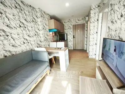 Modern living room with stylish decor and open layout, featuring a cozy sofa and dining area.