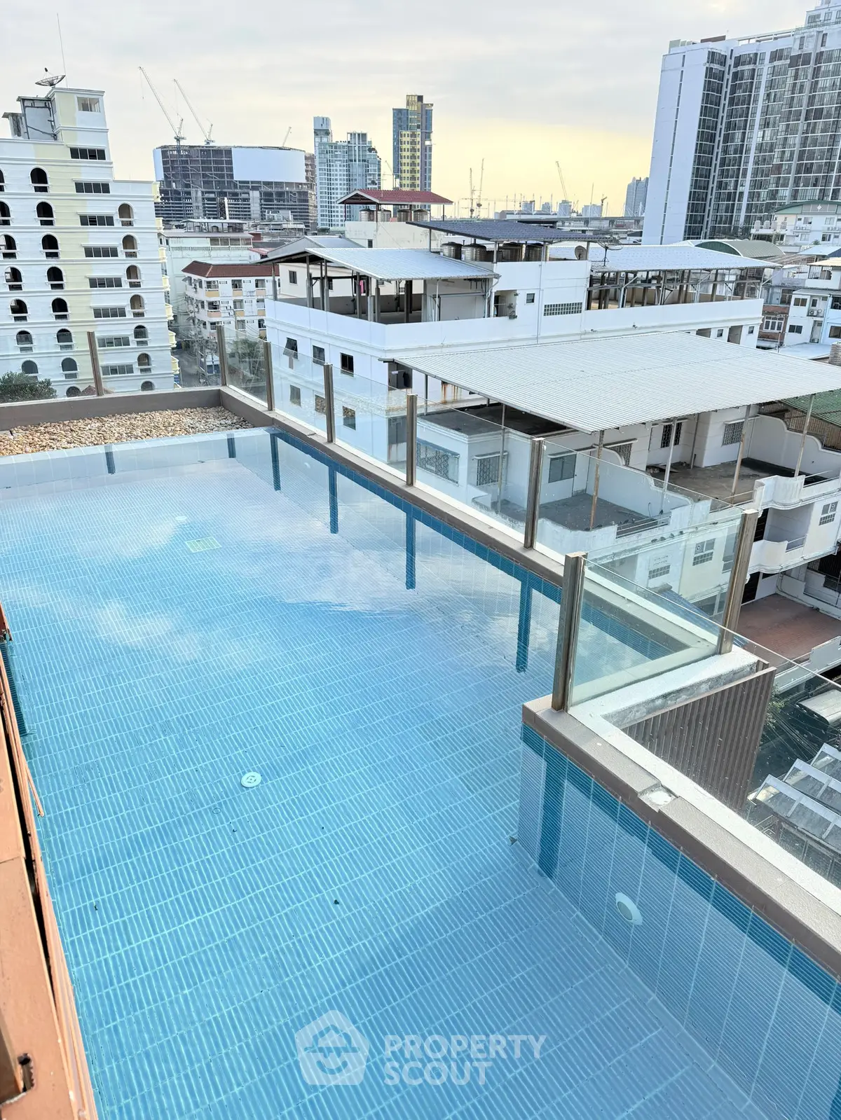 Stunning rooftop pool with panoramic city views in a modern urban setting.
