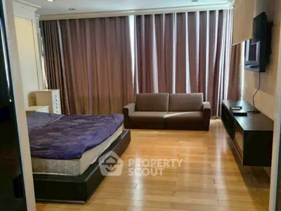 Spacious bedroom with modern furnishings and natural light