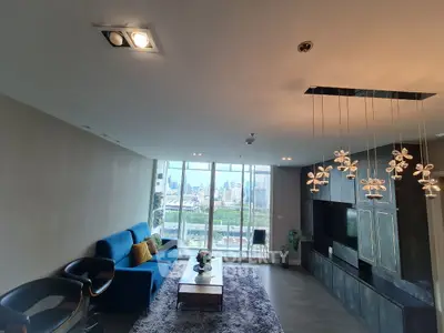 Spacious modern living room with city view and stylish lighting