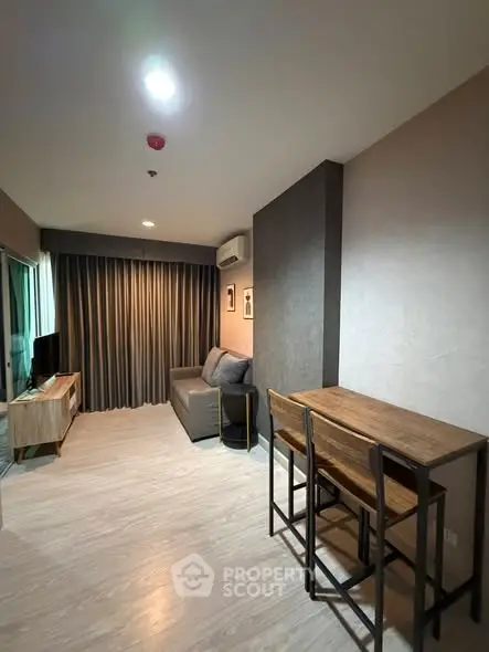 Modern living room with cozy sofa and dining area in stylish apartment