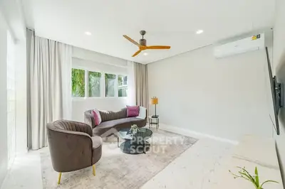 Modern living room with stylish furniture and large windows offering natural light.