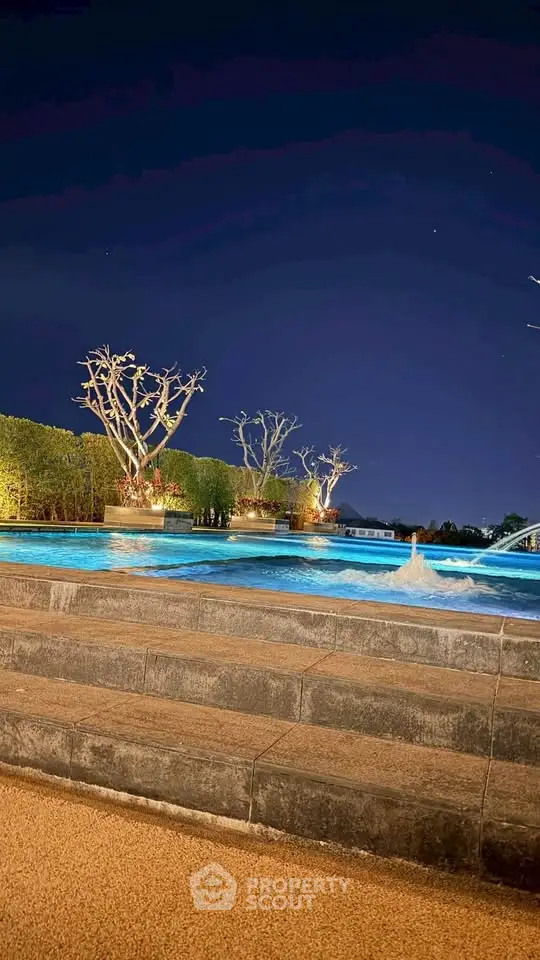 Luxurious rooftop pool with stunning night view and elegant landscaping.