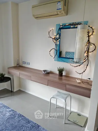Chic modern interior with stylish wall-mounted desk, decorative mirror, and ambient lighting.