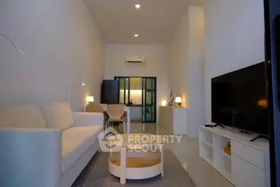 Spacious modern living room with sleek furniture and ambient lighting, perfect for relaxation and entertainment.