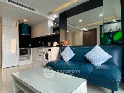 Modern living room with sleek furniture and integrated kitchen appliances.
