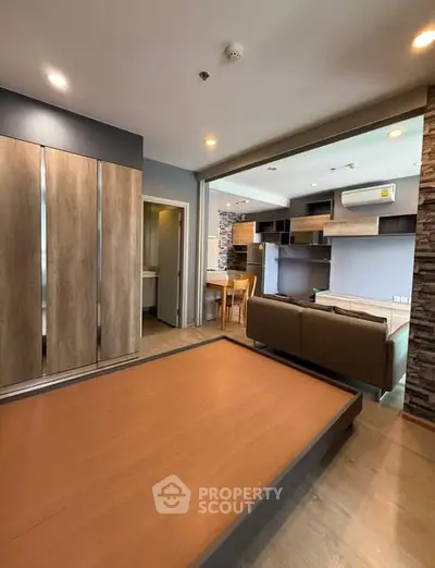 Modern open-plan living room with stylish wood accents and cozy seating area.
