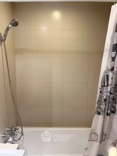 Modern bathroom with shower and bathtub in a cozy apartment.