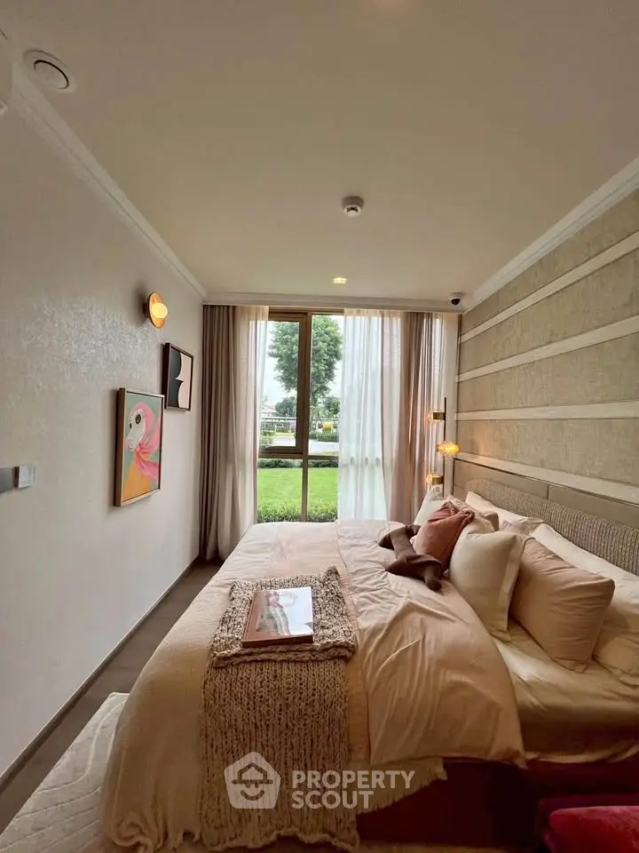 Cozy bedroom with elegant decor and large window overlooking greenery.