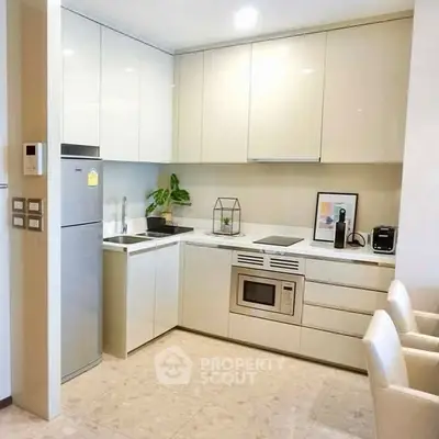 Modern kitchen with sleek cabinets and built-in appliances in a stylish apartment.