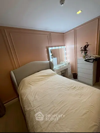 Cozy bedroom with elegant decor and illuminated vanity mirror