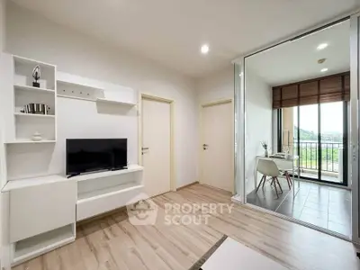 Modern living room with TV and balcony view, featuring sleek wooden flooring and stylish decor.