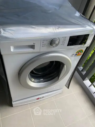 Modern washing machine on a balcony with sleek design and energy efficiency.